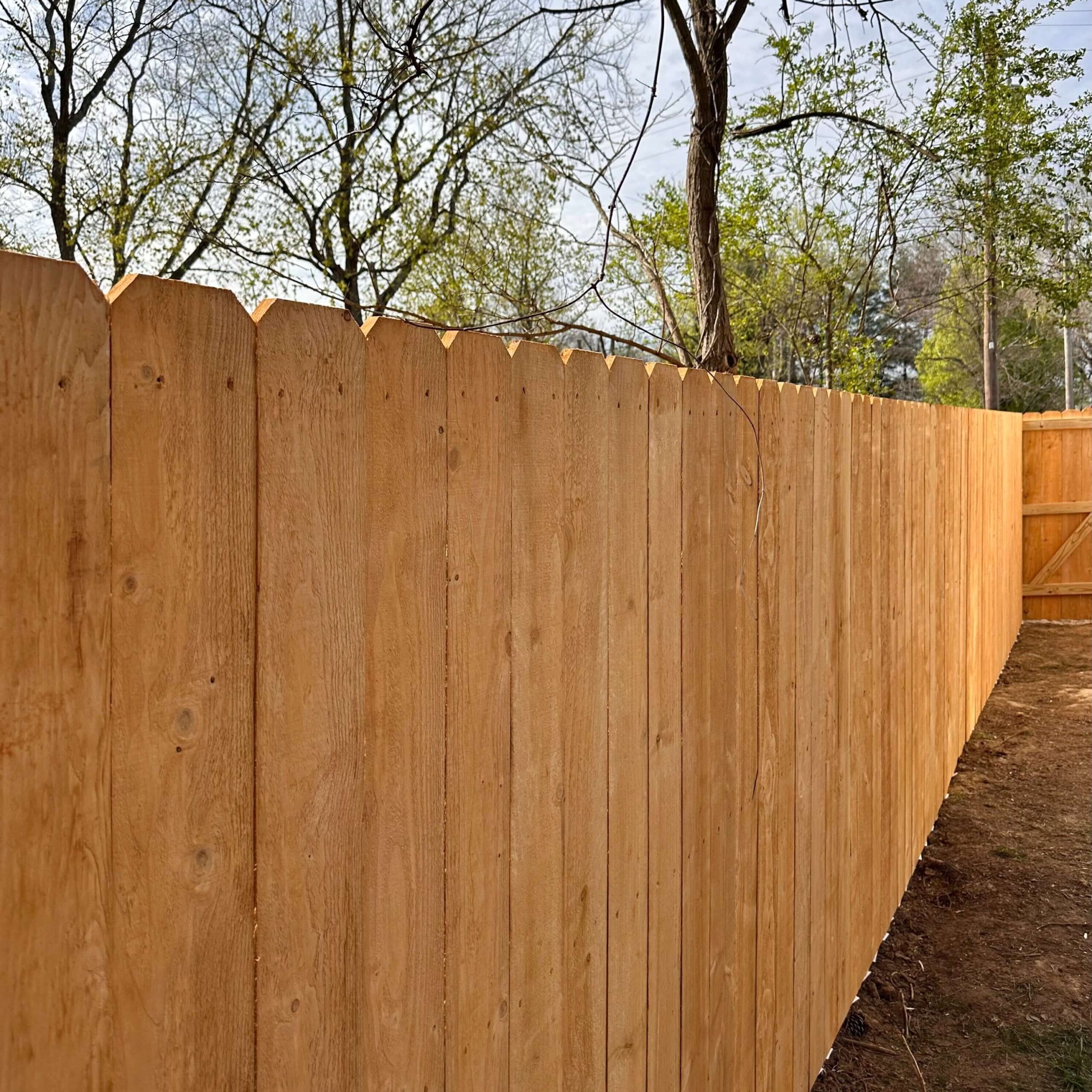 A classic dog-eared wood fence, built for privacy and durability in Franklin.