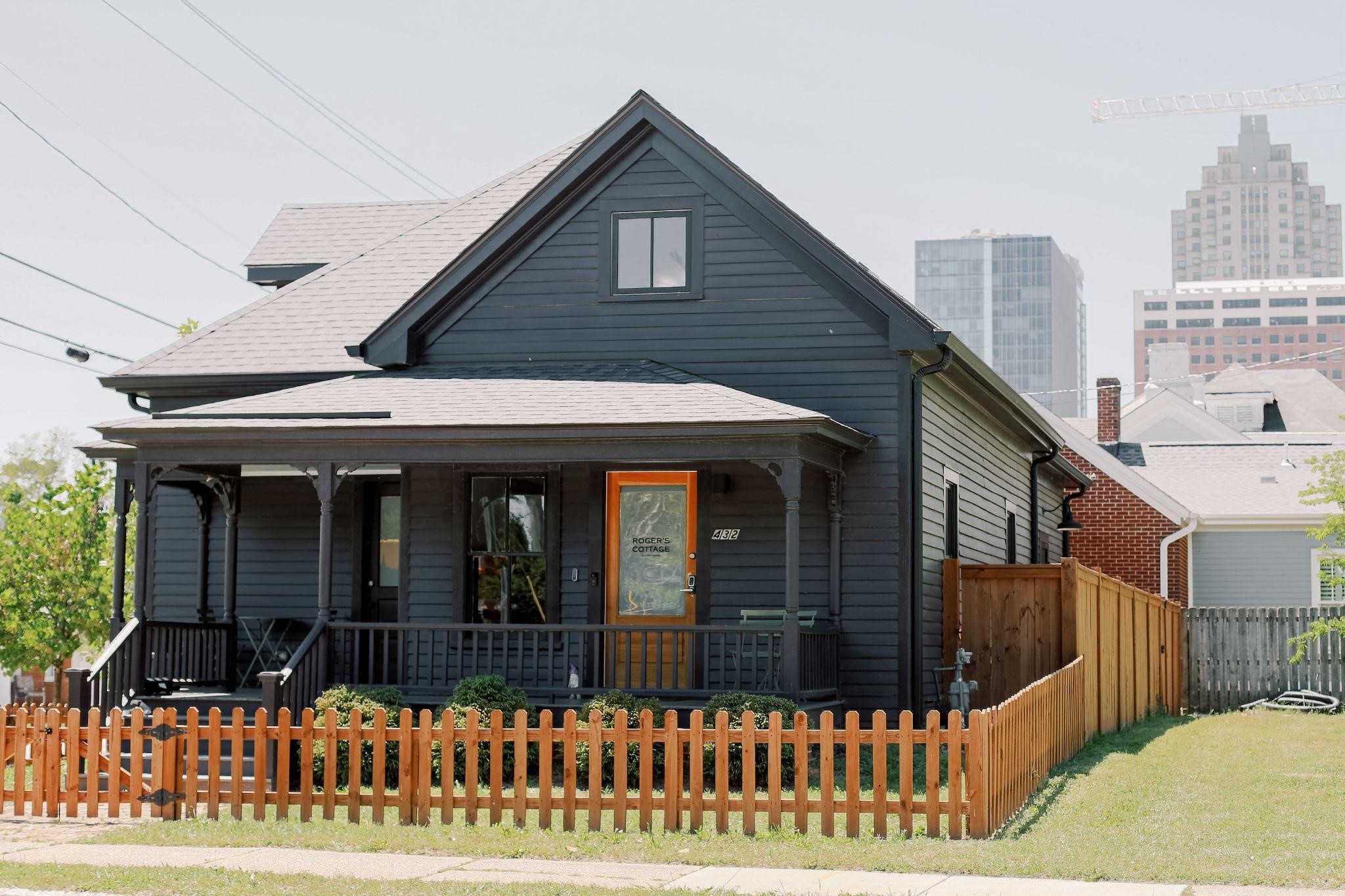 A historic Nashville home with a new cedar picket fence and privacy panels installed along the side yard.