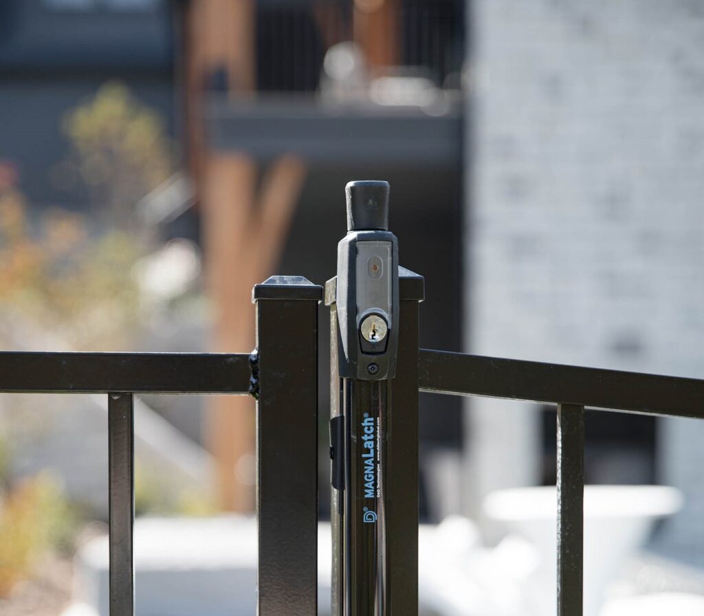 Close-up of a driveway gate latch system for added security.